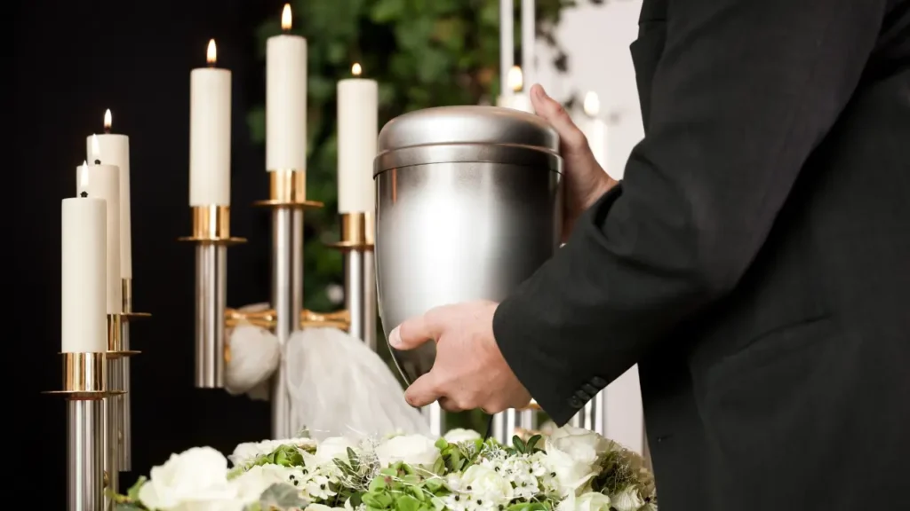 A person carrying the urn at a funeral wake