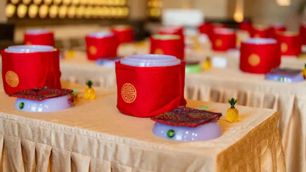 Urns covered in red cloth displayed on tables 