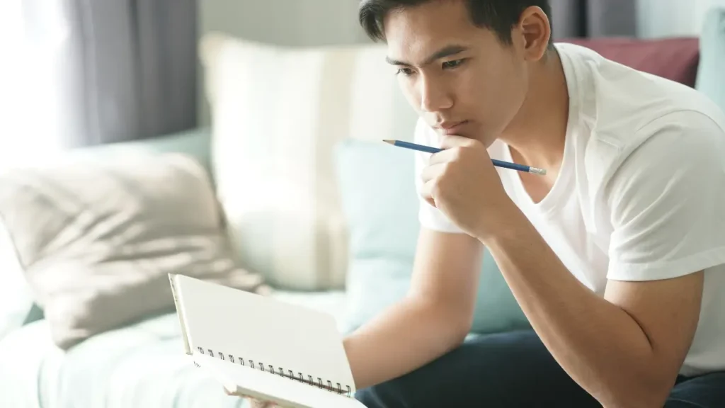 Young man making a check-list and reviewing his pre planned funeral