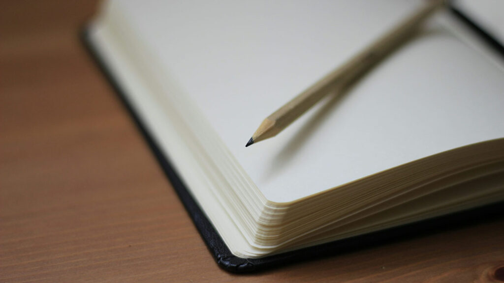 Picture of pencil and notebook for burial planning and committal services