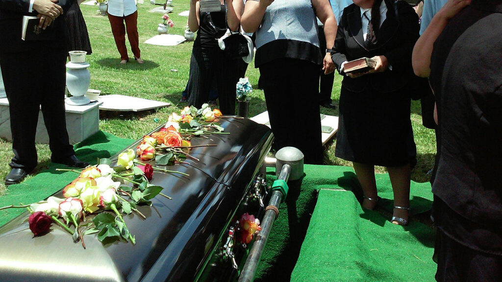 group of people attending burial and funeral procession